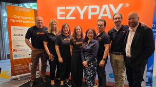 Ezypay team standing in front of company banner
