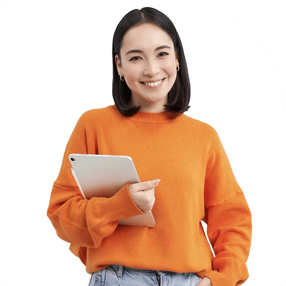 Smiling woman in an orange sweater holds a tablet against a white background. Her casual attire and cheerful expression convey a friendly, relaxed vibe.