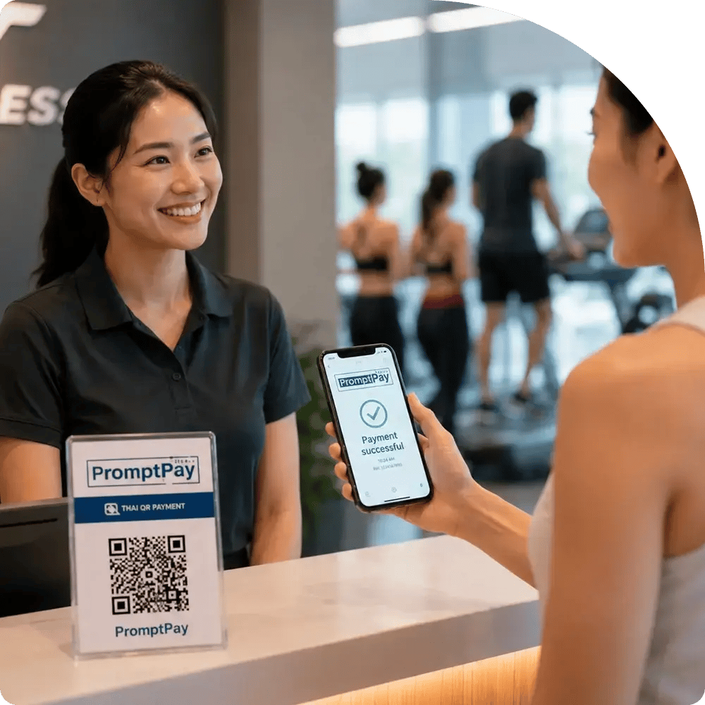 A woman holds a smartphone showing PromptPay app while standing at a front desk, ready to assist visitor.