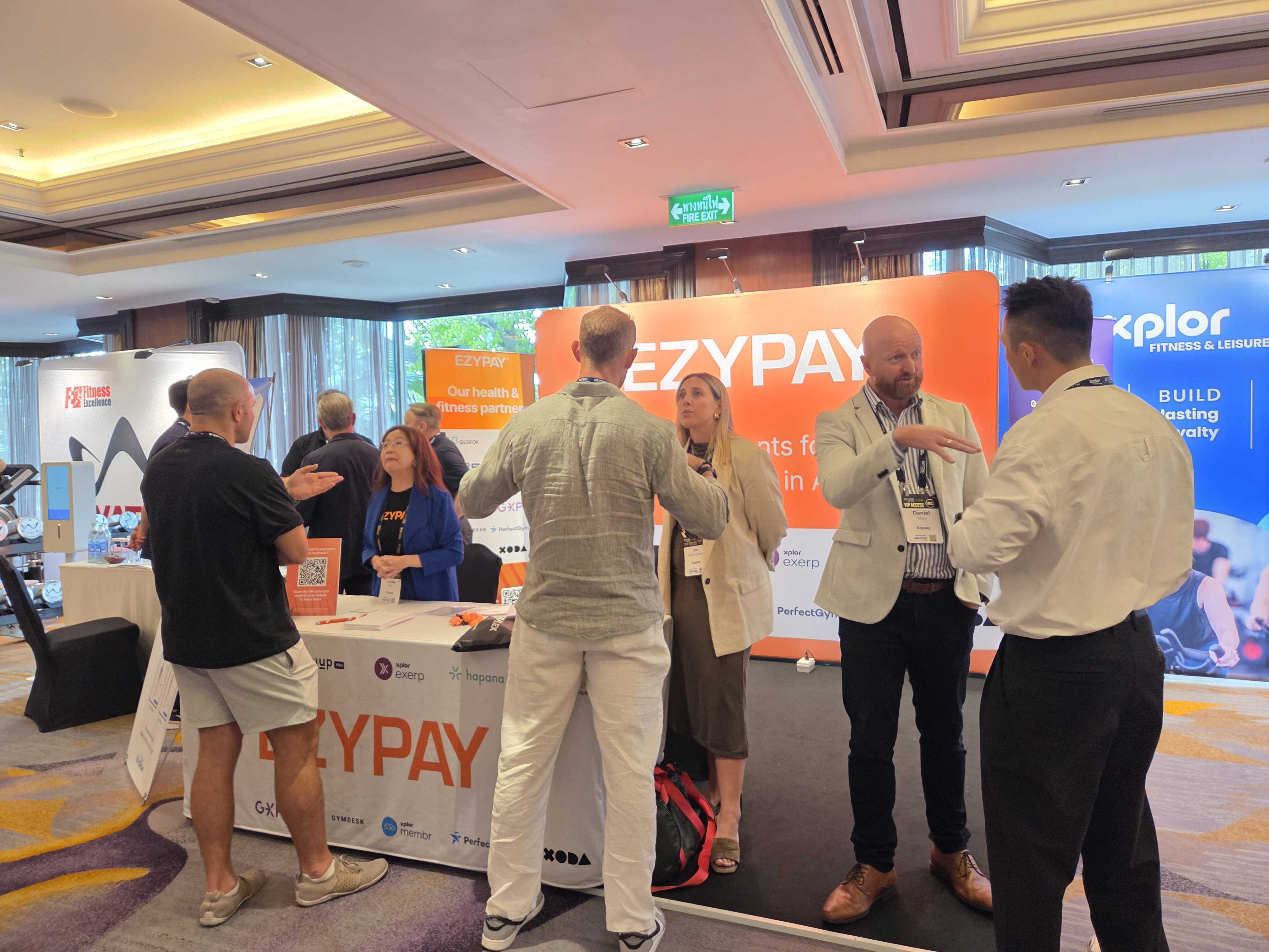 People gathered around Ezypay booth at fitness event