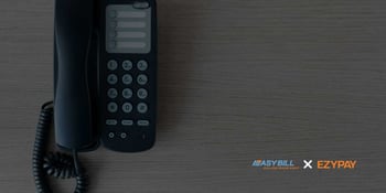 A black landline phone on a wooden surface, with EasyBill and Ezypay logos visible in the lower right corner.