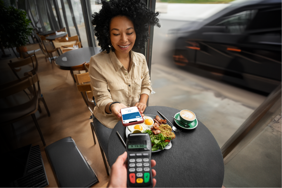 A lady uses Apple pay for her meal