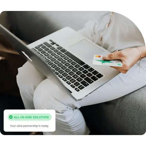 Woman holding credit card with her laptop