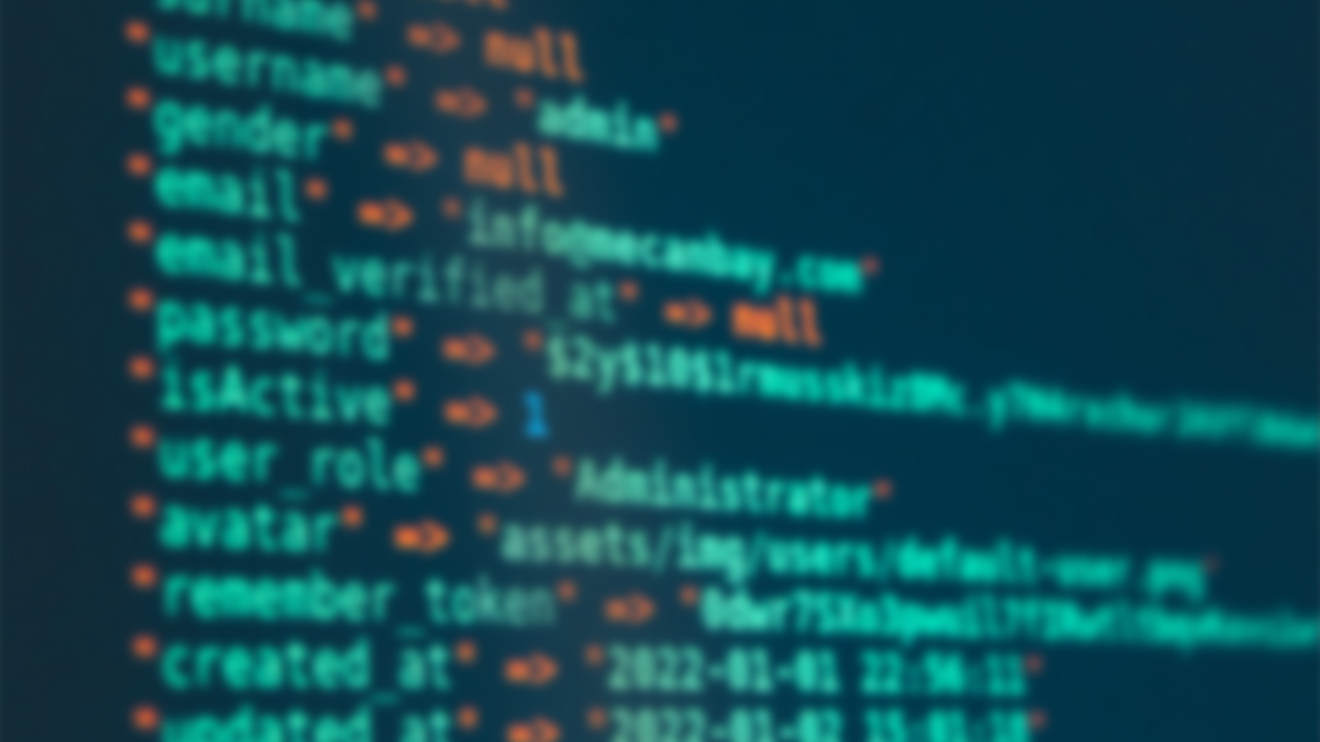 Blurred computer code on a screen with keywords like "username," "email," and "password." The tone is technical, suggesting coding or cybersecurity.