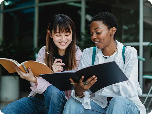 Two students smiling in discussion