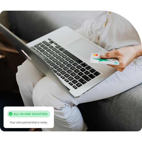Woman holding credit card with her laptop
