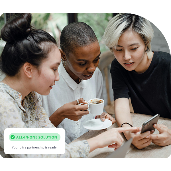 Three women looking at the mobile phone