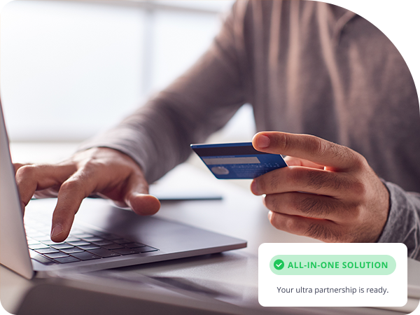 Man holding a credit card with his laptop