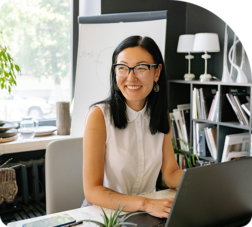 An asian woman smiling at work desk