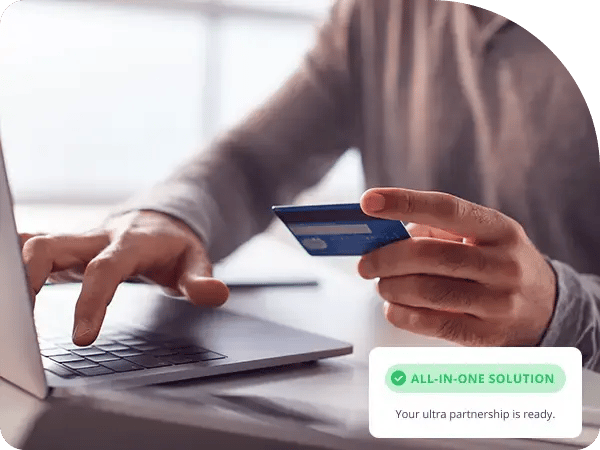 Man holding a credit card with his laptop