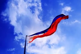 The Philippines flag waving against the blue sky 