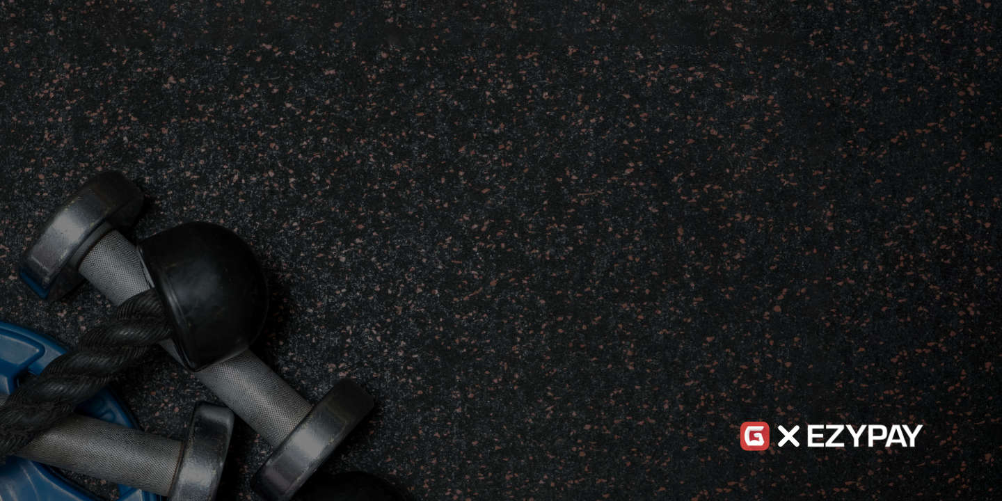 The Gymdesk logo appears next to the Ezypay logo on a black gym mat.