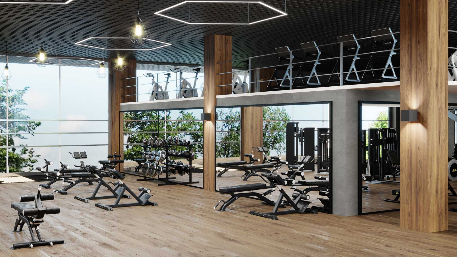 Well lit interior shot of a big box chain gym, including workout equipment